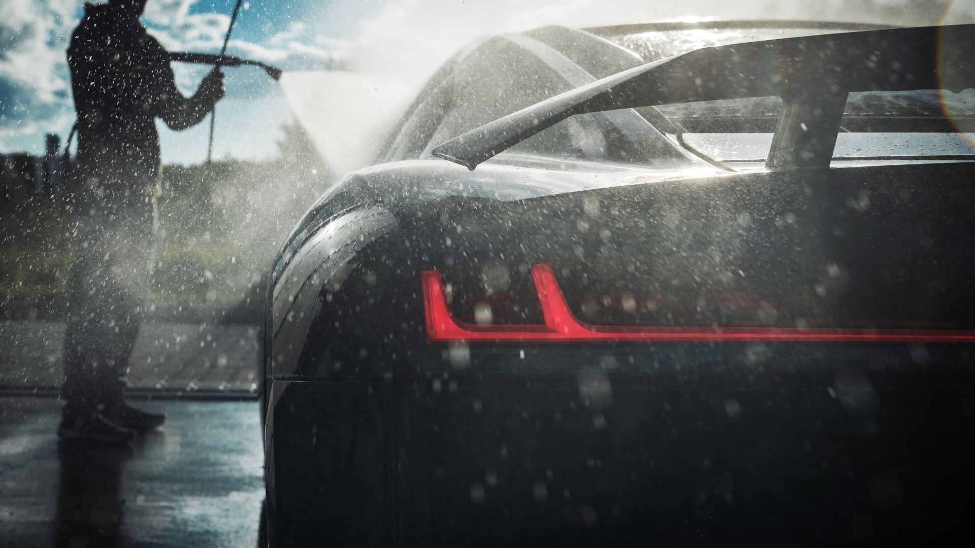 Car with red tail light in snowy weather, silhouette washing windshield