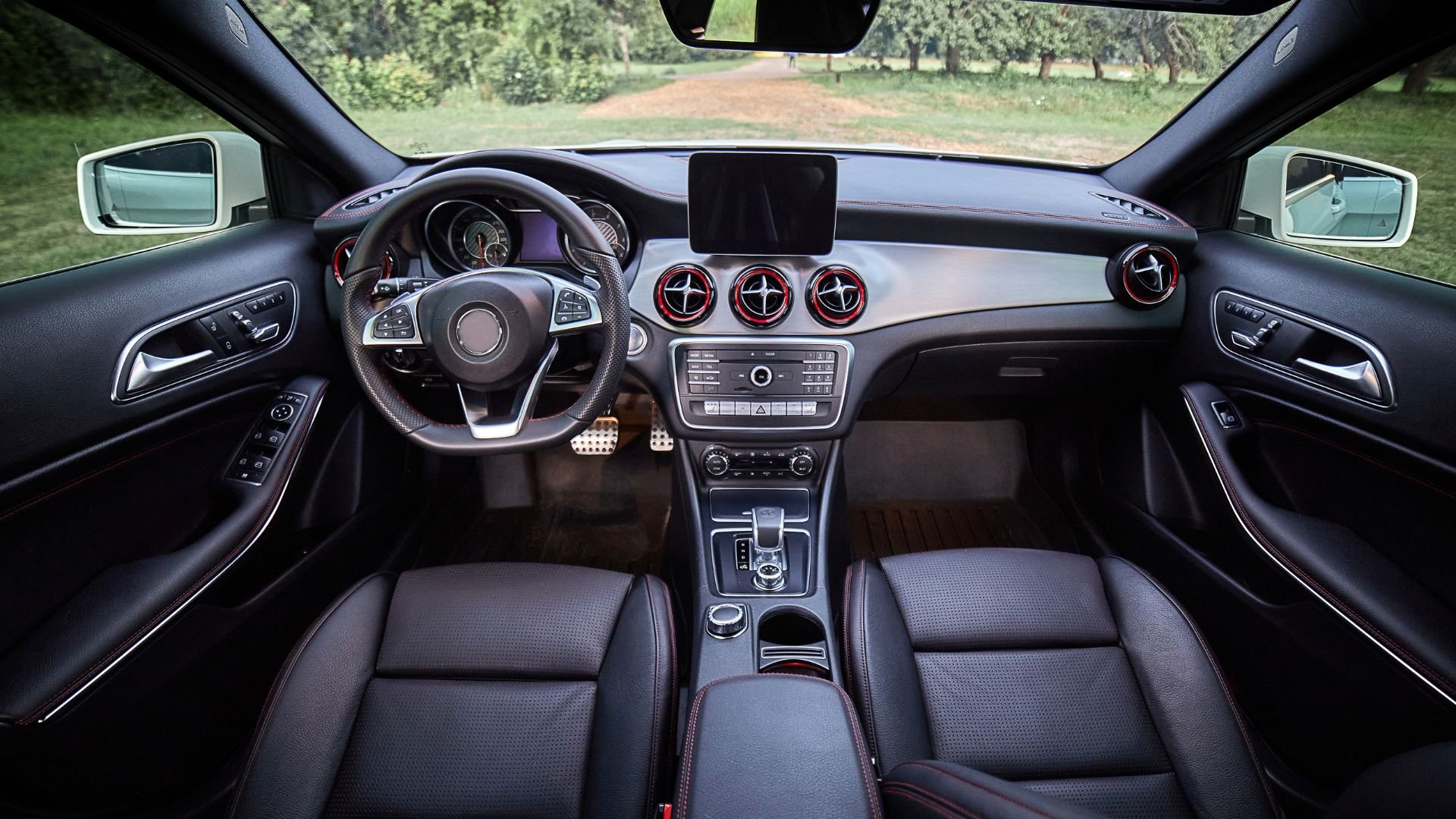 Modern car interior with black leather seats and digital dashboard