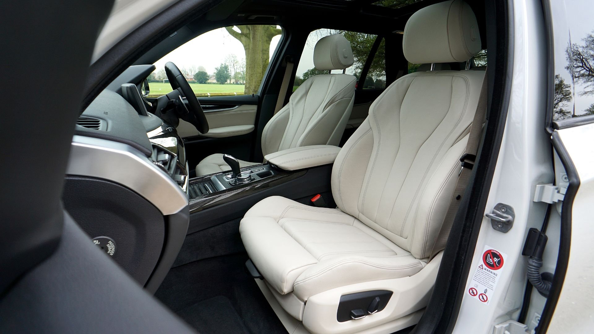 White luxury SUV interior with cream leather seats and modern dashboard